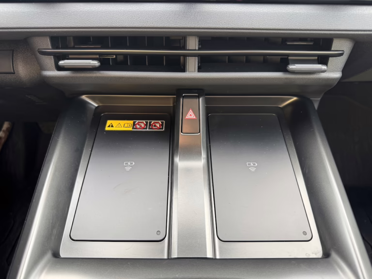 2026 Toyota bZ Woodland dual, wireless smartphone chargers, just ahead of the rotary dial PRNDL.