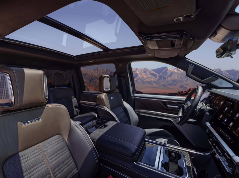 2027 GMC Sierra 1500 AT4X with Timber Mahagony interior with Bright White accents. Interior 3/4 shot from passenger side. Image courtesy of GMC