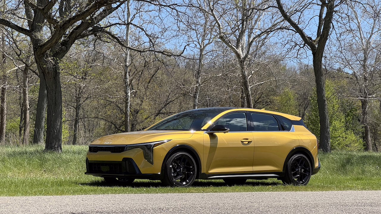 2026 Kia K4 hatchback GT Line Turbo, sparkling yellow, front 3/4. Image by Robin Warner
