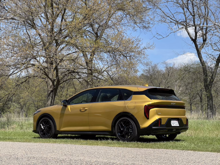 2026 Kia K4 hatchback GT Line Turbo, sparkling yellow, rear 3/4. Image by Robin Warner