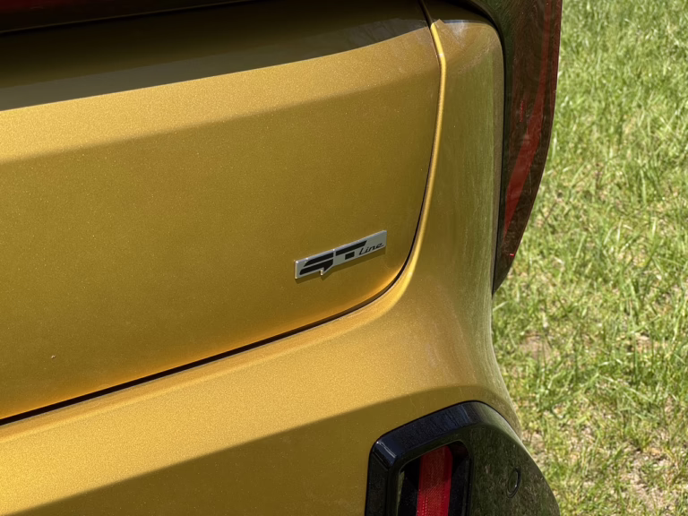 2026 Kia K4 hatchback GT Line Turbo, sparkling yellow, GT Line badge. Image by Robin Warner