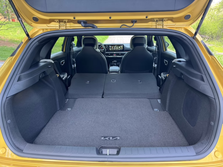 2026 Kia K4 hatchback GT Line Turbo, sparkling yellow, cargo space, seats folded. Image by Robin Warner